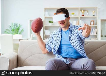 Man wearing virtual reality VR glasses watching american football. Man wearing virtual reality VR glasses watching american footbal