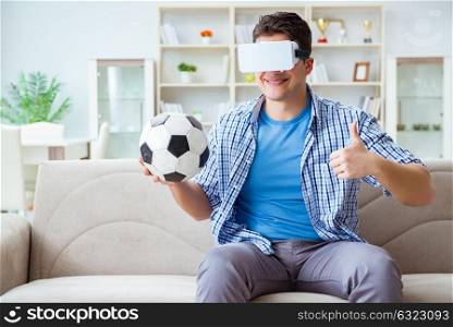 Man wearing virtual reality VR glasses watching soccer football
