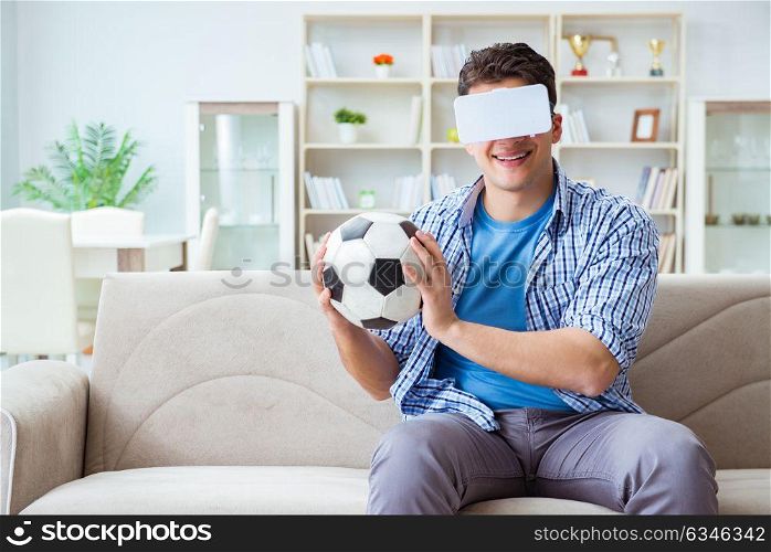 Man wearing virtual reality VR glasses watching soccer football. The man wearing virtual reality vr glasses watching soccer football