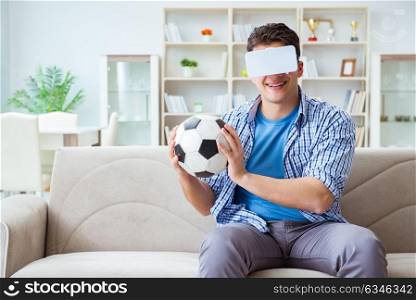 Man wearing virtual reality VR glasses watching soccer football. The man wearing virtual reality vr glasses watching soccer football