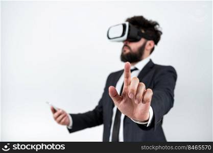 Man Wearing Vr Glasses And Pointing On Important Messages With One Finger.. Man Wearing Vr Glasses And Pointing On Important Messages With One Finger. Businessman Having Virtual Reality Eyeglasses And Showing Crutial Informations.