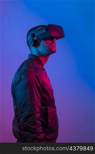 man wearing vr glasses with blue purple light