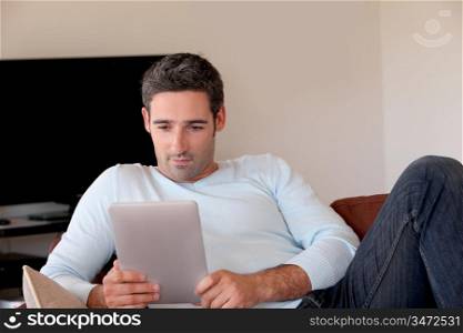 Man websurfing on internet with digital tablet