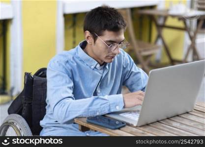 man wheelchair working laptop
