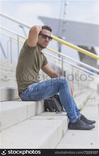 Man who lost job abandoned lost in depression sitting on stairs suffering emotional pain