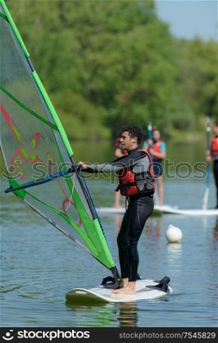man windsurfing in the lake water sport
