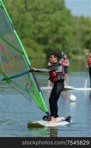man windsurfing in the lake water sport