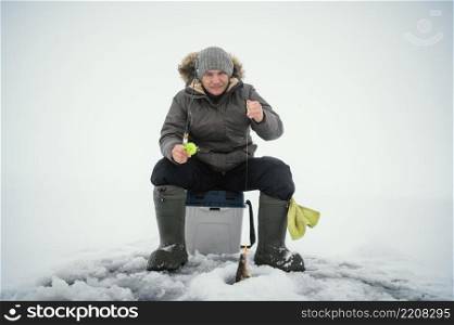 man winter clothes fishing alone outside