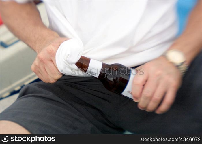 Man Wiping off Beer Bottle