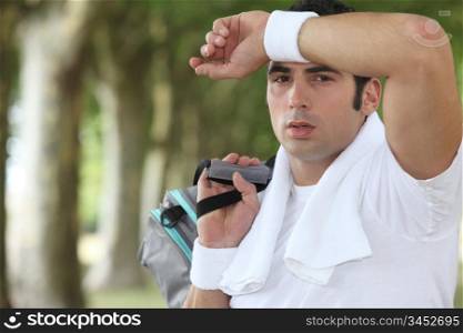 Man wiping sweat from his brow