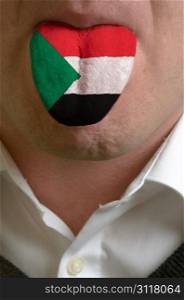 man wit open mouth spreading tongue colored in sudan flag as symbol of values like teaching, learning, multilingual speaking of different languages