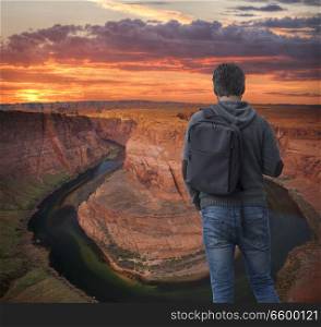 man with a backpack travels across the island of the Colorado River. USA.