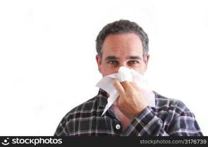 Man with a flu blowing his nose