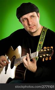 man with a guitar on a green background