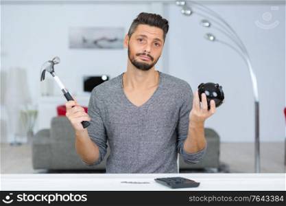 man with a hammer going to break the piggy bank