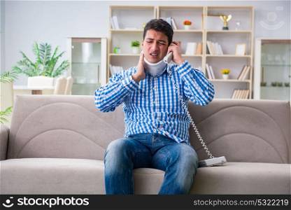 Man with a head neck spine trauma wearing a neck brace cervical . Man with a head neck spine trauma wearing a neck brace cervical collar talking on phone