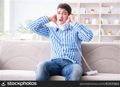 Man with a head neck spine trauma wearing a neck brace cervical . Man with a head neck spine trauma wearing a neck brace cervical collar talking on phone