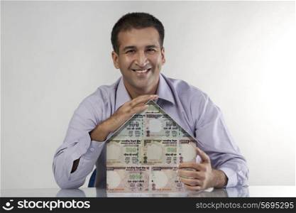 Man with a house model