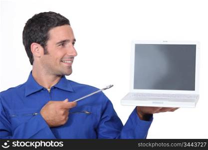 Man with a spanner and laptop computer