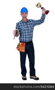 Man with a voltmeter and a trophy in hand