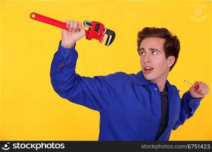 Man with a wrench and screwdriver