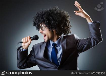 Man with afro haircut singing in studio