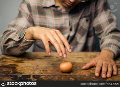 Man with an egg at a desk