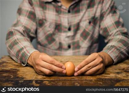 Man with an egg at a desk