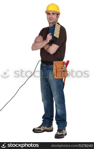 Man with an electric sander