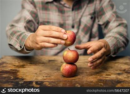 Man with apples on a desk