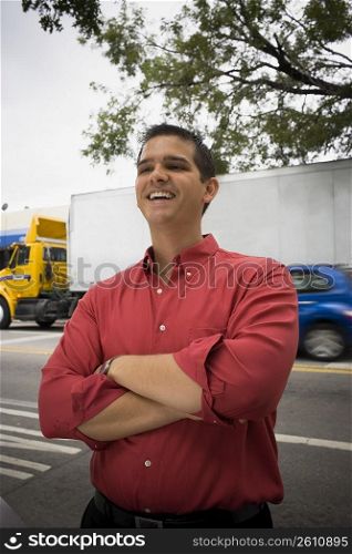 Man with arms crossed looking at camera