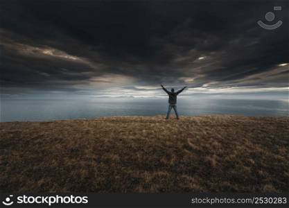 Man with arms raised enjoying the nature in Iceland9