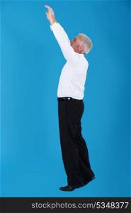 Man with arms up on blue background