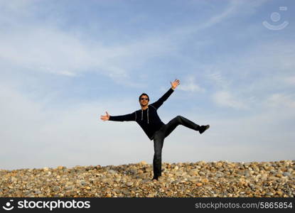 man with arms wide open at the beach