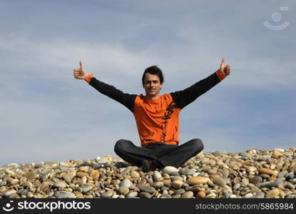 man with arms wide open at the beach