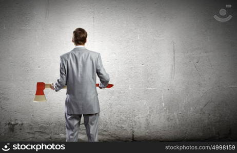 Man with axe. Rear view of businessman holding big axe