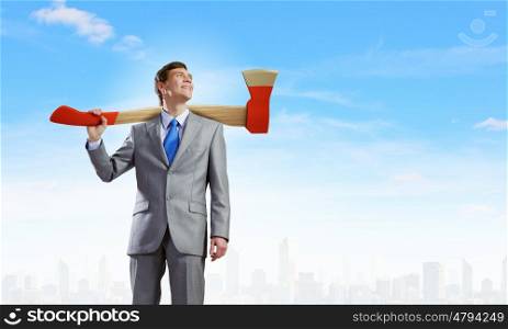 Man with axe. Young businessman holding big axe on shoulder