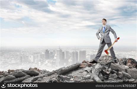 Man with axe. Young determined businessman in suit holding big axe