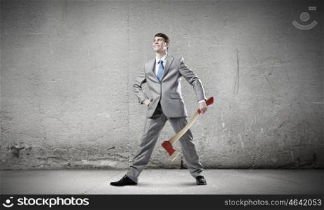 Man with axe. Young determined businessman with axe in hands