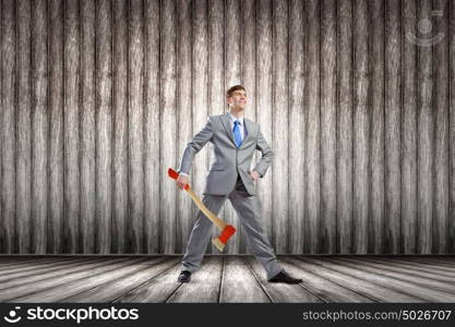 Man with axe. Young determined businessman with axe in hands