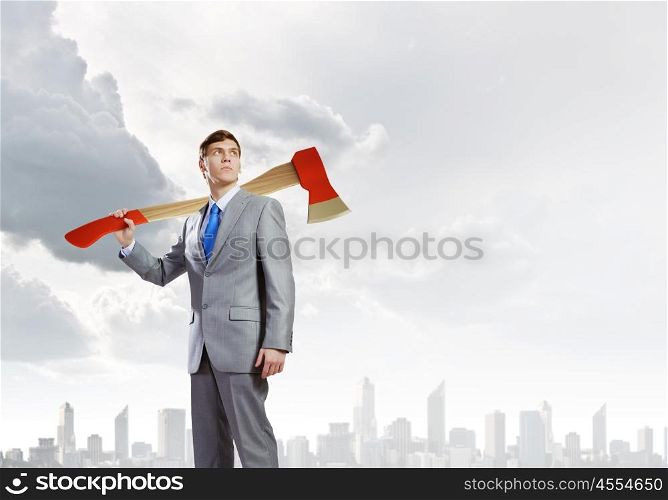 Man with axe. Young determined businessman with axe on shoulder