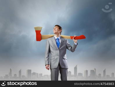 Man with axe. Young determined businessman with axe on shoulder