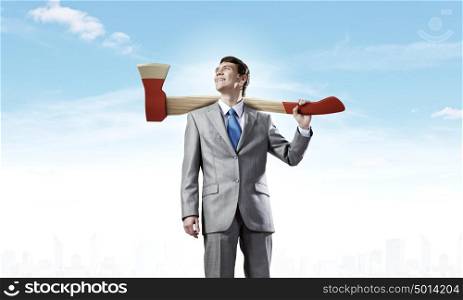 Man with axe. Young determined businessman with axe on shoulder