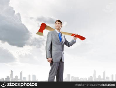 Man with axe. Young determined businessman with axe on shoulder