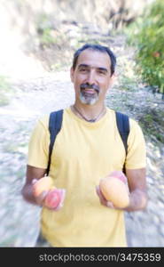 Man with Backpack Holding Mangos