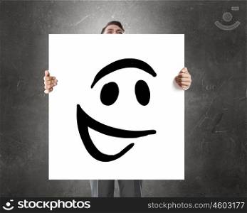 Man with banner. Businessman holding and hiding behind card with smiley face emoticon