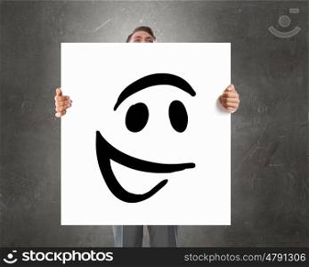 Man with banner. Businessman holding and hiding behind card with smiley face emoticon