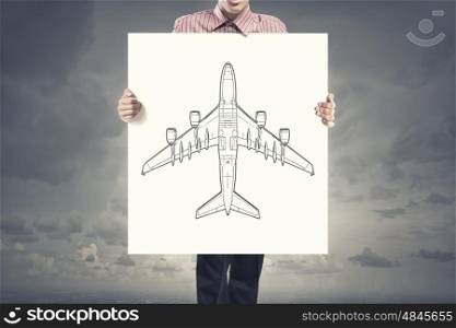 Man with banner. Unrecognizable man showing white banner with airplane design