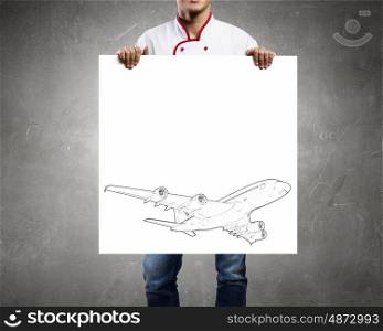 Man with banner. Unrecognizable man showing white banner with airplane design