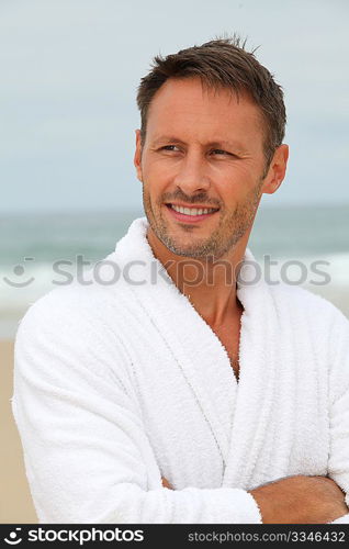 Man with bathrobe on the beach